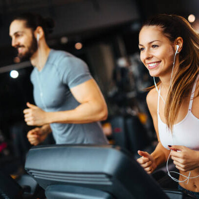 Sporty people running on treadmills in a health club